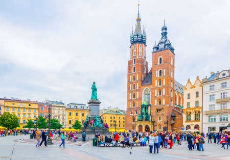 KRAKOW, POLAND, AUGUST 11, 2016: People are passing in front of the church of Saint Mary in the polish city Cracow / Krakow.のeditorial素材