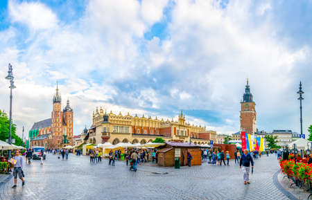 KRAKOW, POLAND, AUGUST 11, 2016: Panorama of the rynek glowny main square with the church of Saint Mary and sukiennice marketplace in the polish city Cracow / Krakow.のeditorial素材