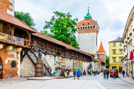 KRAKOW, POLAND, AUGUST 11, 2016: People are admiring work of a street artist exhibited under the historical fortification of the old town of Krakow / Cracow in Poland.のeditorial素材