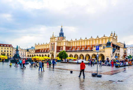 KRAKOW, POLAND, AUGUST 11, 2016: People are strolling in front of the Sukiennice marketplace (Cloth Hall, Drapers' Hall) in Krakow (Cracow), Polandのeditorial素材