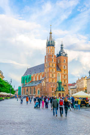 KRAKOW, POLAND, AUGUST 11, 2016: People are passing in front of the church of Saint Mary in the polish city Cracow / Krakow.のeditorial素材