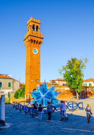 VENICE, ITALY, SEPTEMBER 20, 2015: Glass artwork of blue star and clock tower on Murano island. Venice, Italyのeditorial素材