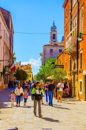 VENICE, ITALY, SEPTEMBER 20, 2015: people are wandering thorugh a narrow street leading towards the Church Il Gesuati or Church Santa Maria del Rosario in italian city veniceのeditorial素材