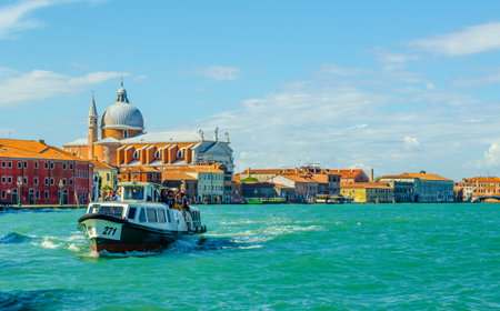 VENICE, ITALY, SEPTEMBER 20, 2015: ferry boat is coming from The Church of Santissimo Redentore ('Holy Redeemer') by Andrea Palladio seen from Giudecca Canalのeditorial素材