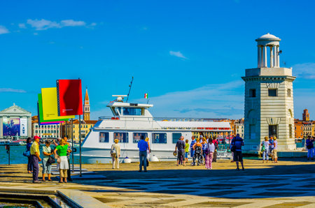 VENICE, ITALY, SEPTEMBER 20, 2015: People are strolling in front of the Church of San Giorgio Maggiore on the island. One of the main attractions of Venice.のeditorial素材