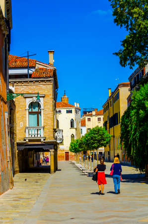 VENICE, ITALY, SEPTEMBER 20, 2015: people are strolling thorugh empty narrow street in italian city venice which is bit further from the main touristic spots.のeditorial素材