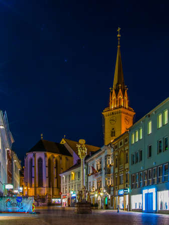 VILLACH, AUSTRIA, FEBRUARY 20, 2016: night view of the illuminated main square - main square with the church of saint jakob in the austrian city villachのeditorial素材