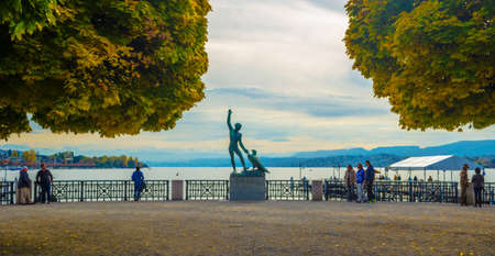 ZURICH, SWITZERLAND, OCTOBER 24, 2015: People are admiring zurich lake from the viewpoint with famous ganimede statueのeditorial素材