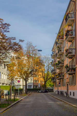 ZURICH, SWITZERLAND, OCTOBER 24, 2015: People are strolling through a narrow street in suburbs of the biggest swiss city zurich.のeditorial素材