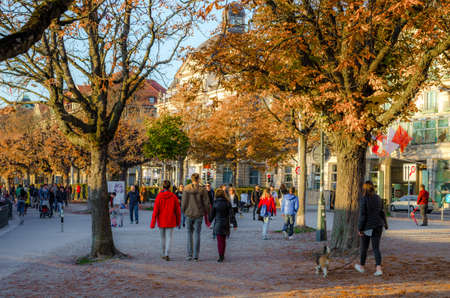 ZURICH, SWITZERLAND, OCTOBER 24, 2015: people are walking on a sunny promenade along the zurich lake in switzerland during late autumn afternoonのeditorial素材