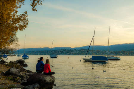 ZURICH, SWITZERLAND, OCTOBER 24, 2015: people are walking on a sunny promenade along the zurich lake in switzerland during late autumn afternoonのeditorial素材