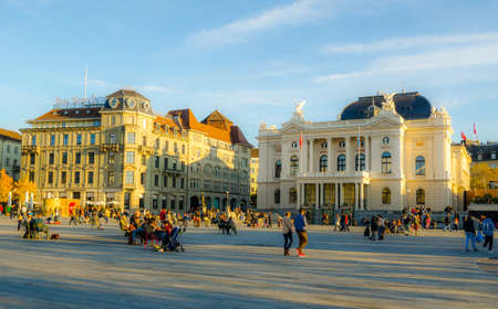 ZURICH, SWITZERLAND, OCTOBER 24, 2015: People are passing by Sechsenlautenplatz in the swiss city zurich which is dominated by the majestic building of opera.のeditorial素材