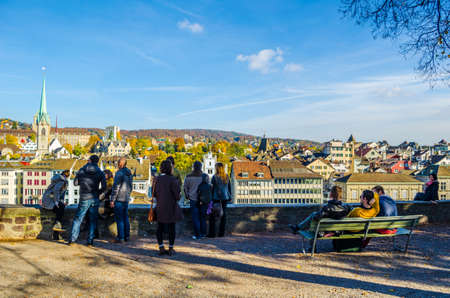 ZURICH, SWITZERLAND, OCTOBER 24, 2015: people are enjoying sunny day and view over zurich in autumn in the lindenhof parkのeditorial素材