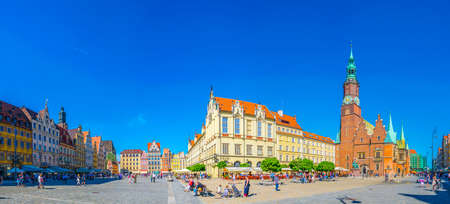 WROCLAW, POLAND, MAY 28, 2017: People are passing beautiful town hall at Rynek, the picturesque...