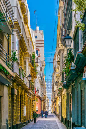 CADIZ, SPAIN, JANUARY 6, 2016: people are stolling through a narrow street in historical center of spanish city cadizのeditorial素材