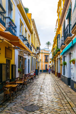 SEVILLA, SPAIN, JANUARY 7, 2016: people are stolling through a narrow street situated in the center of the spanish city sevillaのeditorial素材