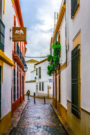 CORDOBA, SPAIN, JANUARY 8, 2016: people are strolling through whitewashed streets of the jewish...
