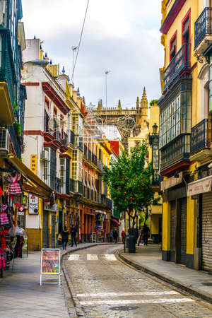 SEVILLA, SPAIN, JANUARY 7, 2016: people are stolling through a narrow street situated in the center of the spanish city sevillaのeditorial素材