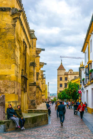 CORDOBA, SPAIN, JANUARY 8, 2016: people are passing by under the Torre del Alminar Bell Tower of the mezquita cathedral in the spanish city sevillaのeditorial素材