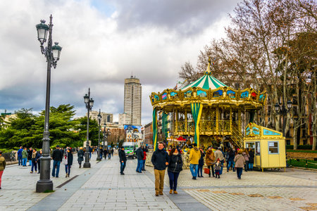 MADRID, SPAIN, JANUARY 9, 2016: People are walking on a street next to the royal palace in madrid
