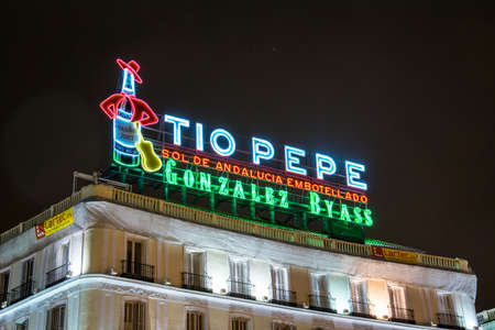 MADRID, SPAIN, JANUARY 9, 2016: night view of one of the symbols of Madrid - neon commercial of Tio Pepe above the puerta del sol squareのeditorial素材