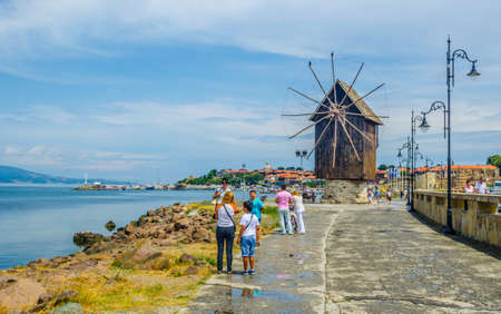 NESSEBAR, BULGARIA, JULY 14, 2015: People are passing an old windmill on the way to the unesco world heritage city nessebar in bulgaria.のeditorial素材