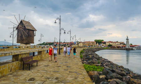 NESSEBAR, BULGARIA, JULY 14, 2015: People are passing an old windmill on the way to the unesco world heritage city nessebar in bulgaria.のeditorial素材
