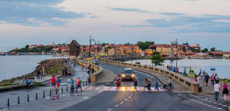 NESSEBAR, BULGARIA, JULY 14, 2015: People are passing an old windmill on the way to the unesco world heritage city nessebar in bulgaria.のeditorial素材