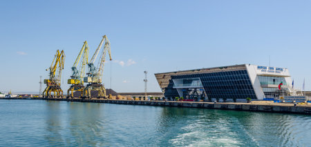 BURGAS, BULGARIA, JULY 17, 2015: heavy cranes in bulgarian port bourgas are used for unloading cargo ships. In the vicinity is the pasenger ferry terminal.のeditorial素材