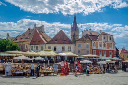 SIBIU, ROMANIA, JULY 6, 2015: Unidentified people visit the Small Square, the second fortified square in the medieval Upper town of Sibiu city.のeditorial素材