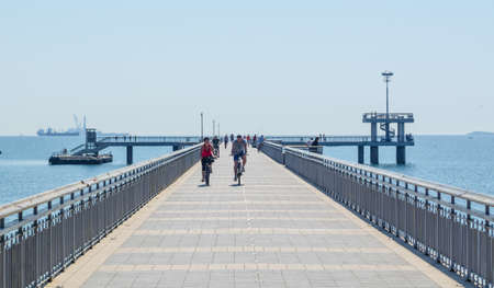 BURGAS, BULGARIA, JULY 15, 2015: View of a quay leading into the black sea near bulgarian city burgas. People are enjoying sunny day walking towards the sea while being refresed by gentle breeze.のeditorial素材