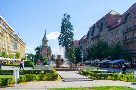 TIMISOARA, ROMANIA, JULY 4, 2015: Victory square - piata victoriei - timisoara is a long square with green park surrounded by national opera on one side and the metropolitan cathedral on the other.のeditorial素材
