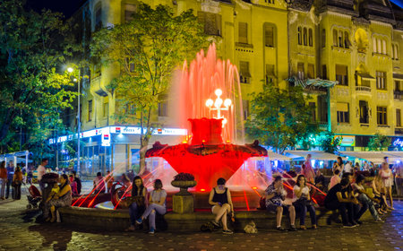 TIMISOARA, ROMANIA, JULY 4, 2015: fountain in the middle of victory square - piata victoriei - in romanian timisoara is a popular meeting spot for locals especially after sunset when nightlife begins.のeditorial素材