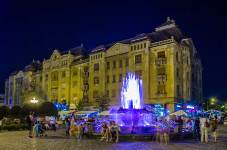 TIMISOARA, ROMANIA, JULY 4, 2015: fountain in the middle of victory square - piata victoriei - in romanian timisoara is a popular meeting spot for locals especially after sunset when nightlife begins.のeditorial素材