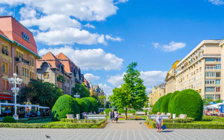 TIMISOARA, ROMANIA, JULY 4, 2015: Victory square - piata victoriei - timisoara is a long square with green park surrounded by national opera on one side and the metropolitan cathedral on the other.のeditorial素材