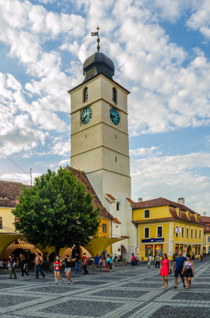 SIBIU, ROMANIA, JULY 6, 2015: Tourists visiting medieval downtown of Sibiu, with Council Tower in Large Square, Transylvania in Romania.のeditorial素材