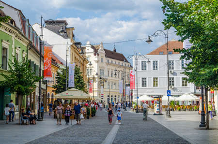 SIBIU, ROMANIA, JULY 6, 2015: people stroll along the boulevard nicolae balcescu or enjoy a sunny day in the Great Square, the largest square in the upper town and an architectural monument by UNESCO.のeditorial素材
