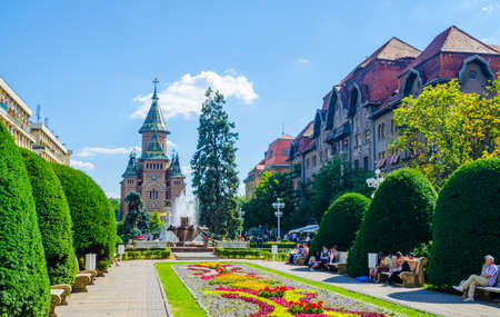 TIMISOARA, ROMANIA, JULY 4, 2015: Victory square - piata victoriei - timisoara is a long square with green park surrounded by national opera on one side and the metropolitan cathedral on the other.のeditorial素材