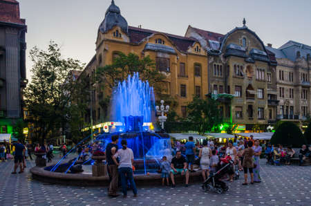 TIMISOARA, ROMANIA, JULY 4, 2015: fountain in the middle of victory square - piata victoriei - in romanian timisoara is a popular meeting spot for locals especially after sunset when nightlife begins.のeditorial素材