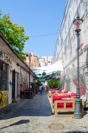 BUCHAREST, ROMANIA, JULY 11, 2015: view of a minor street inside of the old town of romanian capital Bucharest where people usually relax during hot summer days.のeditorial素材