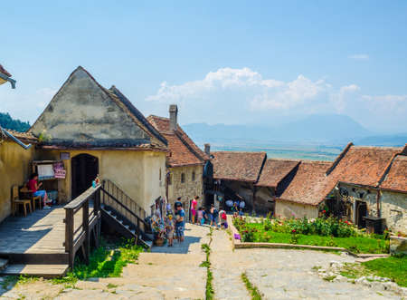 RASNOV, ROMANIA, JULY 8, 2015: View of a traditional craft market inside of the rasnov fortress in romania where crowds of tourists buy traditional romanian souvenirs.のeditorial素材