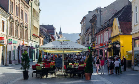 BRASOV, ROMANIA, JULY 9, 2015: Street of the republic is a center of nightlife of romanian city Brasov. During summer this street is flooded by open restaurants and bars.のeditorial素材