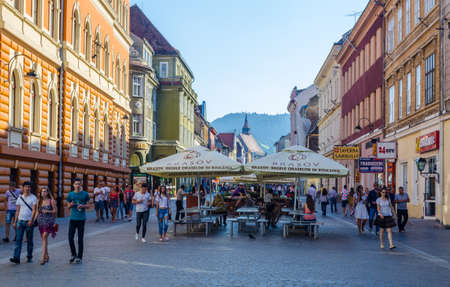 BRASOV, ROMANIA, JULY 9, 2015: Street of the republic is a center of nightlife of romanian city Brasov. During summer this street is flooded by open restaurants and bars.のeditorial素材