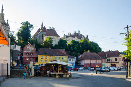 SIGHISOARA, ROMANIA, JULY 9, 2015: View of a small square in the new town of romanian city sighisoara. Sighisoara is considered the most beautiful and well preserved inhabited citadel in Europe.のeditorial素材