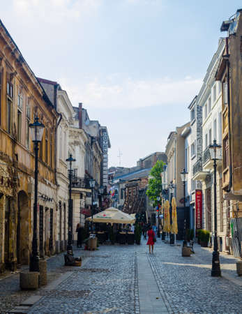 BUCHAREST, ROMANIA, JULY 11, 2015: view of a minor street inside of the old town of romanian capital Bucharest where people usually relax during hot summer days.のeditorial素材
