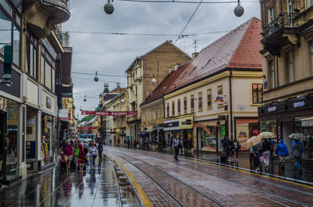 ZAGREB, CROATIA, JULY 28, 2015: people are walking through ilica street in the croatian capital zagreb during rainy summer day.のeditorial素材