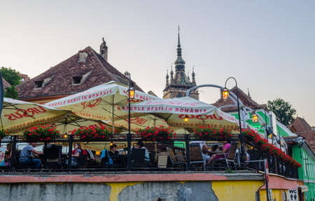 SIGHISOARA, ROMANIA, JULY 9, 2015: View of a typical romanian restaurant with a summer terrace in romanian city sighisoaraのeditorial素材