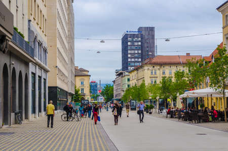 LJUBLJANA, SLOVENIA, JULY 29, 2015: Unrecognizable pedestrians walk along central Slovenska Street in front of Hotel Slon and Central Post. Ljubljana is the biggest city and capital of Slovenia.のeditorial素材