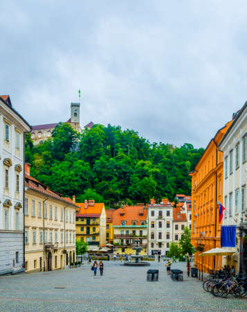 LJUBLJANA, SLOVENIA, JULY 29, 2015: Novi trg - New city square in the slovenian capital Ljubljana is overlooked by a castle situated on a hill across ljubljanica river. Ljubljana is the capital and largest city of independent Slovenia since 1991.のeditorial素材
