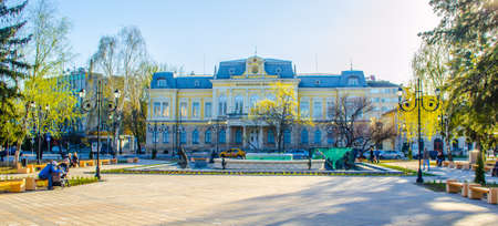 RUSE, BULGARIA, MARCH 5, 2015: people are sitting in a park in front of the museum of history in bulgarian city ruse.のeditorial素材